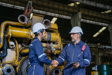 Technicians work at train engine repair shop.