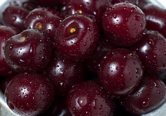 Fresh ripe cherries with water drops, as background.