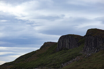 Majestic cliffs and dramatic skies above the Isle of Skye highlight Scotland's natural beauty during a serene day