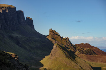 Explore the stunning landscapes of Quiraing pass on Isle of Skye in Scotland during a clear blue sky day