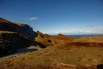Breathtaking panoramic view of Quiraing pass on the Isle of Skye in Scotland showcasing rugged landscapes and clear blue skies