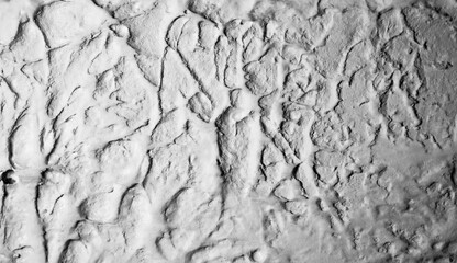 Sliding stone plaster in the image of a lifeless cold desert in the form of abstraction