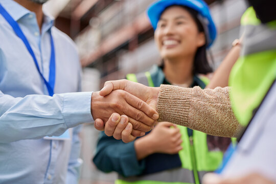 Close up of construction workers handshake