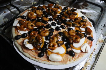 Homemade pizza with shrimp and olives