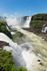 Spectacular view of the devil's throat Iguazu Falls on a sunny day, National Park in Brazil. The closest view of the waterfalls making a lovely rainbow