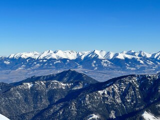 mountain panoramatic view of High Tatras in winter time with snow-covered peaks