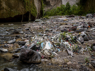 Stunning Yet Troubled Canyon Landscape: Polluted River Winding Through Lush Green Cliffs And Rocky...