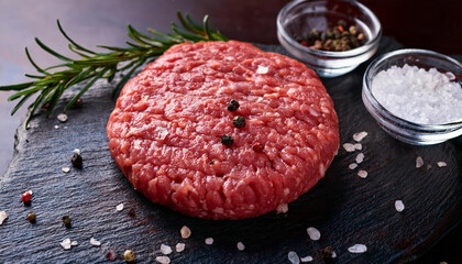 fresh raw ground beef burger patty with salt and spices