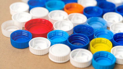 A collection of plastic caps in various colors and sizes. The caps are arranged in a pattern, with...