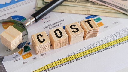 Cost text on wooden block on chart background, Business Concept
