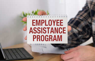 Word Employee Assistance Program text on white paper on light background