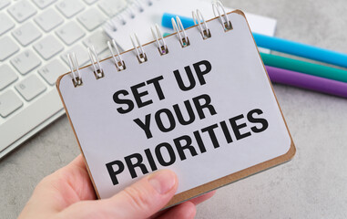 Set Up Your Priorities Text on an Open Notebook on notebook paper, Pen, Business Concept
