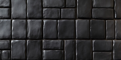 Obraz premium Close-up of glossy black tiles arranged in a geometric pattern, creating a modern and sleek texture ideal for architectural or interior design concepts.