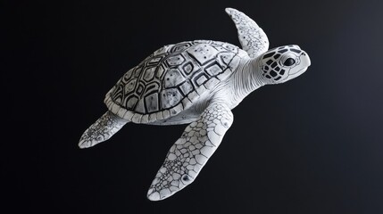 Fototapeta premium Intricate black and white sea turtle sculpture on dark background