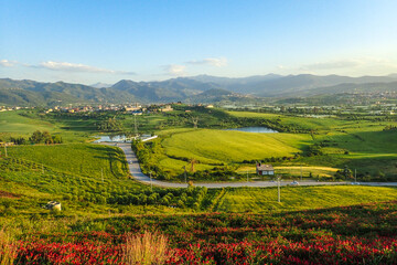 Obraz premium African countryside, Spring day landscape of fields, meadows and hills with mountains in the background and blue sky with clouds, Algerian and a lake in the Algerian countryside, rural Jijel Algeria.