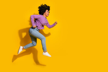 Full length photo of pretty young woman jump run empty space isolated on yellow color background