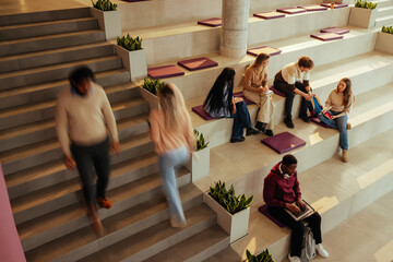 University students studying and walking in modern bleacher-like classroom