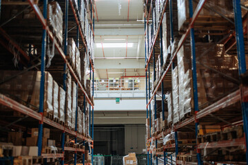 Fototapeta premium Large warehouse with organized shelves and mezzanine level