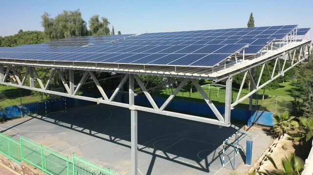 Aerial drone view of solar panel rooftops on residential and commercial buildings, showcasing renewable energy and sustainability. Perfect for concepts of eco-friendly power generation, green tec