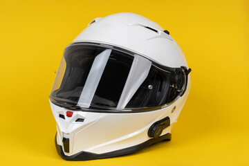 White motorcycle carbon integral crash helmet on yellow white. High quality motorcycle helmet
