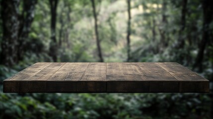 Fototapeta premium Wood table top in front of of trees in the forest. blur background image, for product display montage