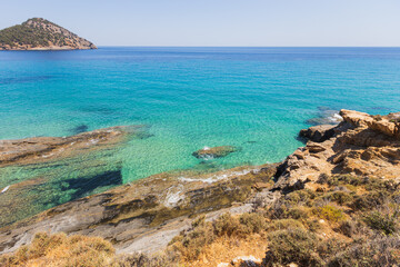 Fototapeta premium Crystal Clear Turquoise Sea Waters Along the Rocky Coastline at Summer Day