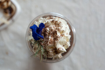 Whipped cream in takeaway cup. Top view