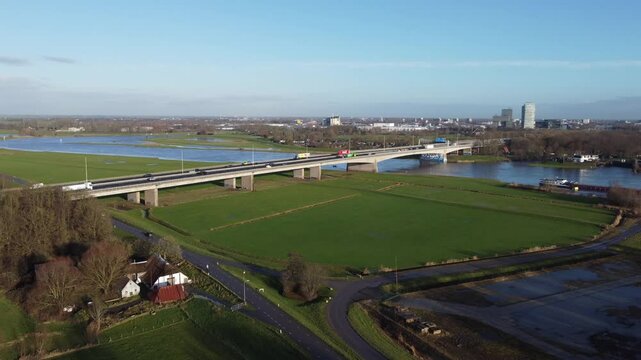 Zwolle, the Netherlands - January 8th 2025: Aerial footage of drone closing in on the A28 or E232 highway bridge crossing the river IJssel into Overijssels capital Zwolle.