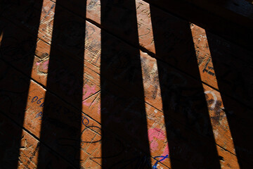 Shadow and light, contrast, Drawn table. Table with inscriptions. Sun. Abstraction. Sunny day. Tree. Wooden table. Graffiti