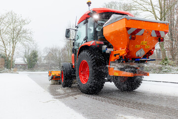 snow removal equipment cleans the snow and sprinkles the road with reagents. Salt