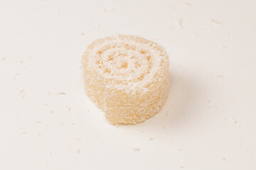 Coconut candy roll isolated on a white background.