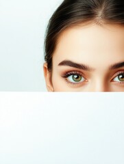 Close-up portrait of a beautiful young woman with striking green eyes, partially obscured by a blank white sheet, showcasing fresh skin and natural makeup, beauty, fashion, elegance.