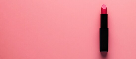 Obraz premium Cosmetician pink lipstick on minimalistic pastel pink background ideal for beauty product promotion and makeup artistry concept
