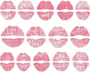 A collection of lipstick stains from women's lips on a white background