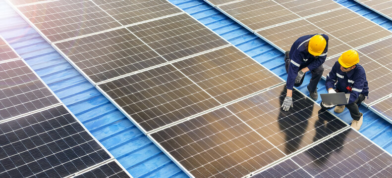 Professional inspecting solar panel installations on a rooftop ensuring renewable energy efficiency and sustainability practices highlighting clean energy technologies and environmental benefits. - Powered by Adobe