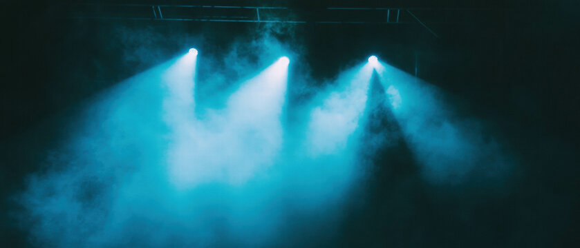 Spotlight beams creating ethereal atmosphere in dense fog during a dramatic performance