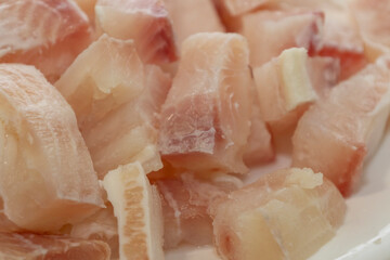 Pangasius fish fillet by pieces. Fresh fish fillet.
