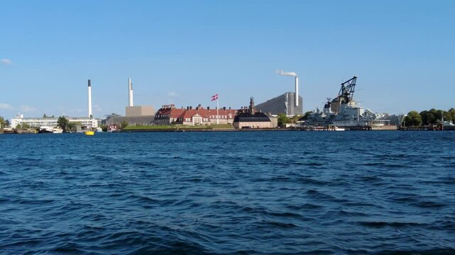 Smooth lateral view of historic warship at Holmen and museum in the harbor of Copenhagen, Denmark at summer with blue sky