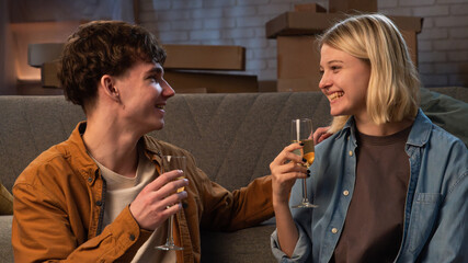 A young man and woman are in the living room discussing a housewarming.