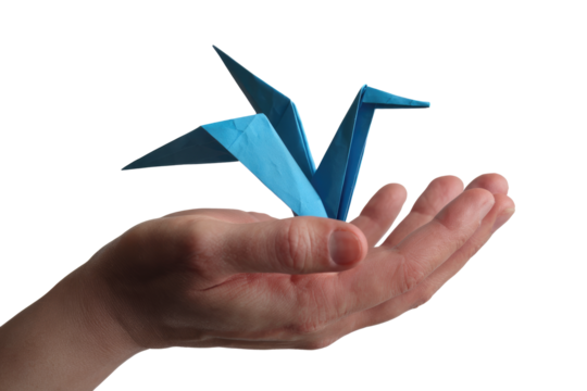 A hand gently cradles a delicate blue origami crane, a symbol of peace and hope. background removed - Powered by Adobe