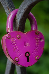 Pink love Lock attached to a fence