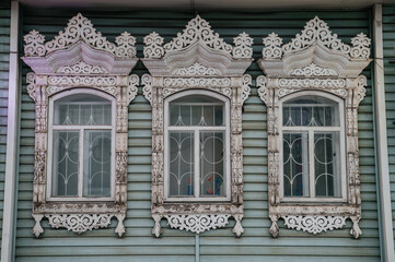 carved window frames in log houses in a Russian village