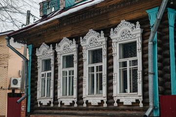 Fototapeta premium carved window frames in log houses in a Russian village