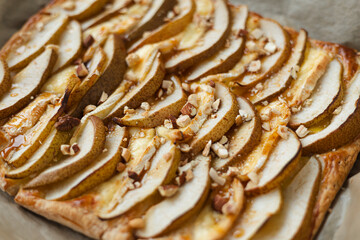 Puff pastry pie with camembert, pear slices, honey and nuts.