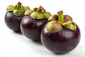 Fototapeta premium Fresh Mangosteens with Green Crown on White Surface