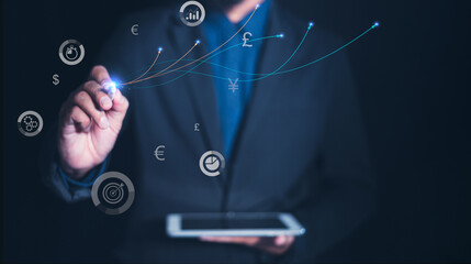 A businessman professional using a tablet to interact with digital financial icons and graphs, symbolizing data analysis and technological advancement.