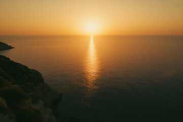Obraz premium Beautiful sunset over the sea with an orange sky and sun, a summer landscape