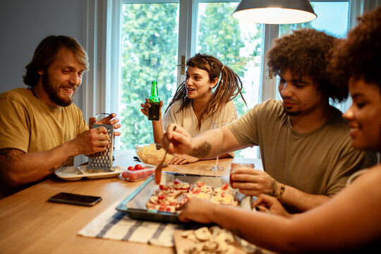 Friends cooking together in a cozy kitchen