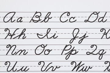 Cursive writing alphabet practice on lined paper