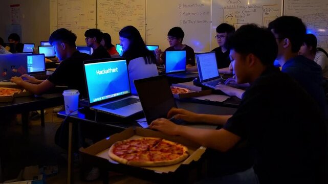 Students Collaborate on Projects During an Intense Night Hackathon With Pizza and Laptops